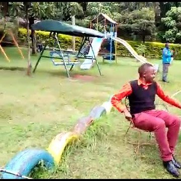 A therapist working with a child in the NEIC garden